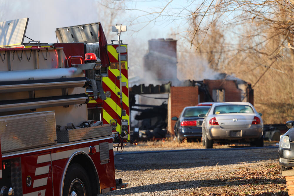 photo of a house fire and fire truck